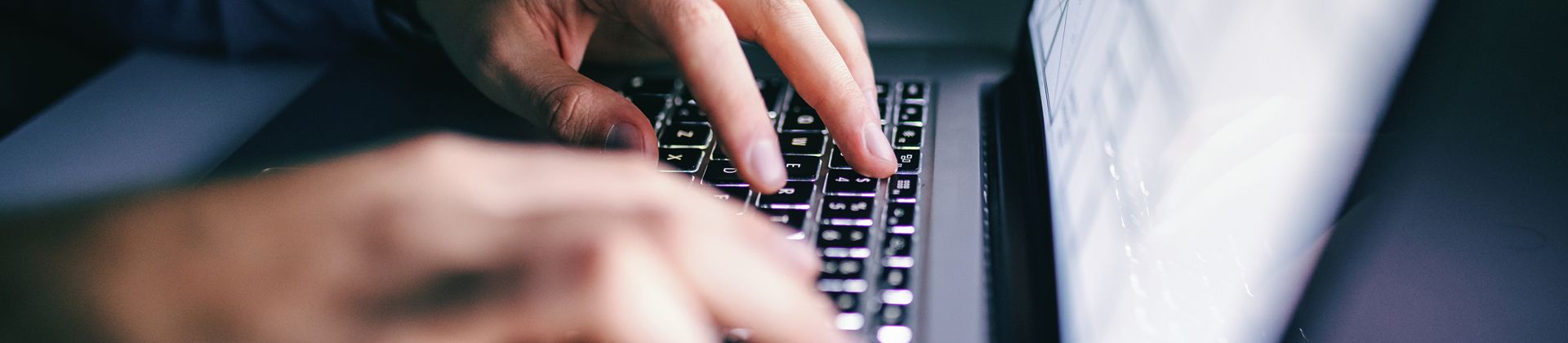 Closeup of hands on a laptop keyboard for the Master of Science in Computer Science Program Page