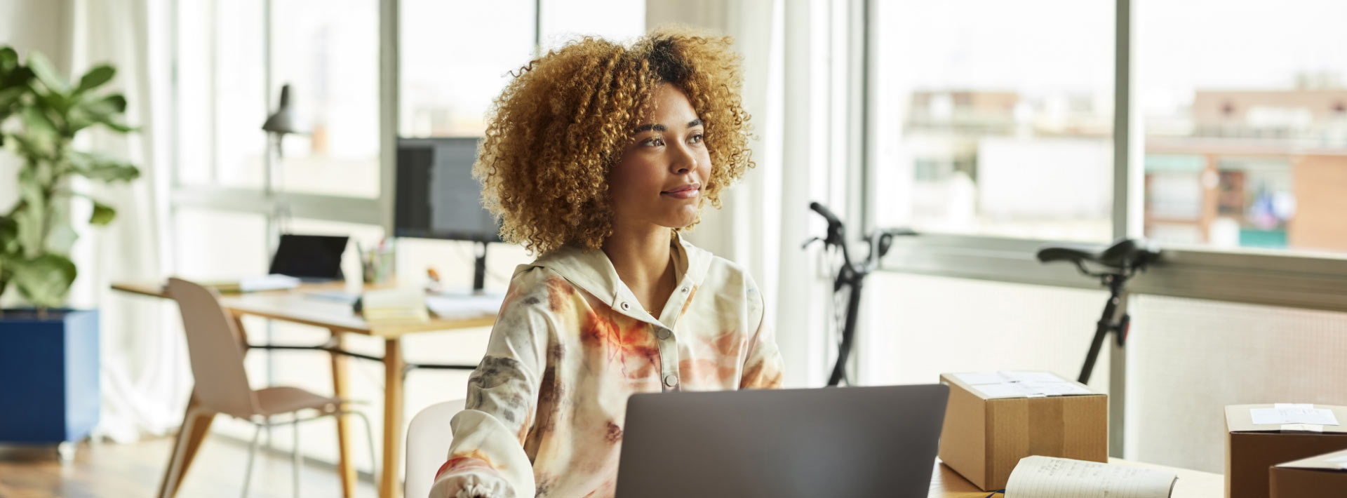 Person sitting in front of laptop in office