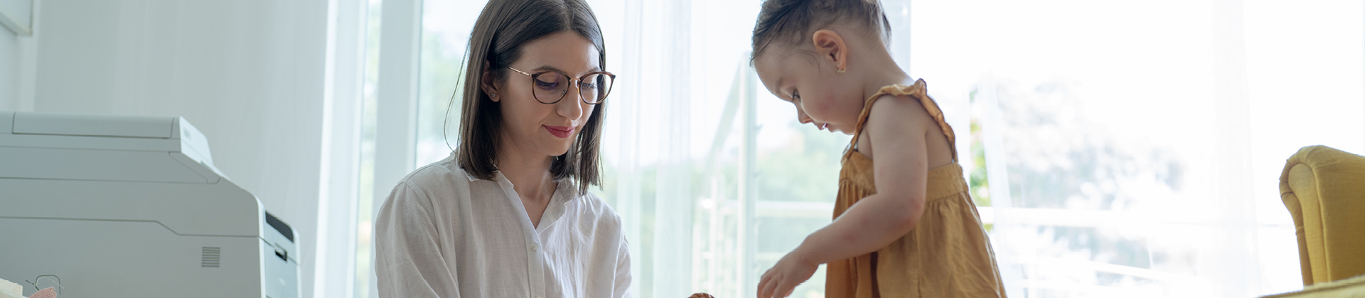 mother and toddler looking down with slight smiles