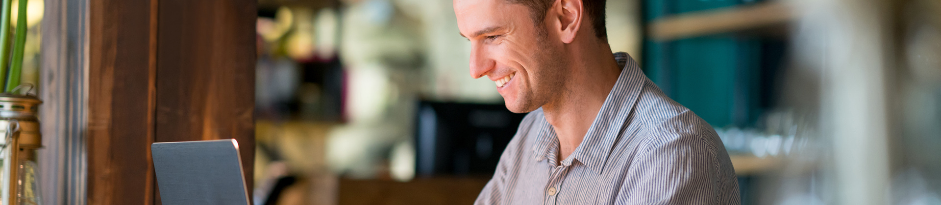 man smiling maniacally as he gazes downward 