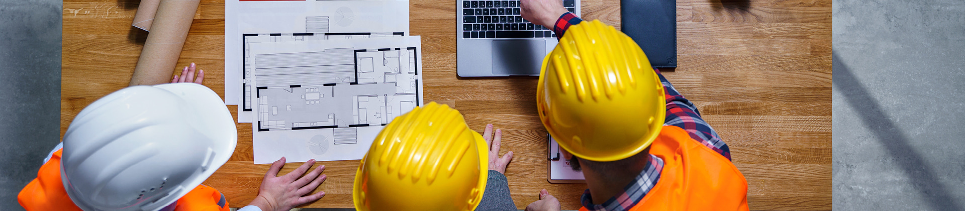 construction workers looking at blueprints