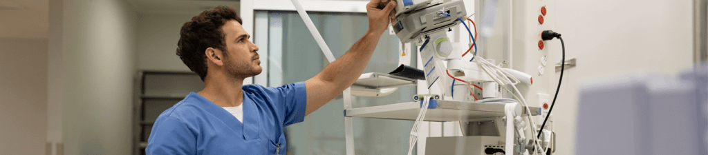 medical professional looking up at vitals monitor