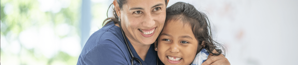 female nurse hugging  a child. Qualities Should a CNA Possess 